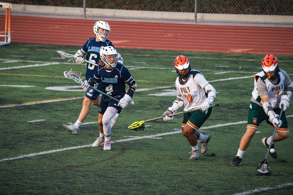 High school lacrosse action: Lions vs Poly players competing for a ground ball